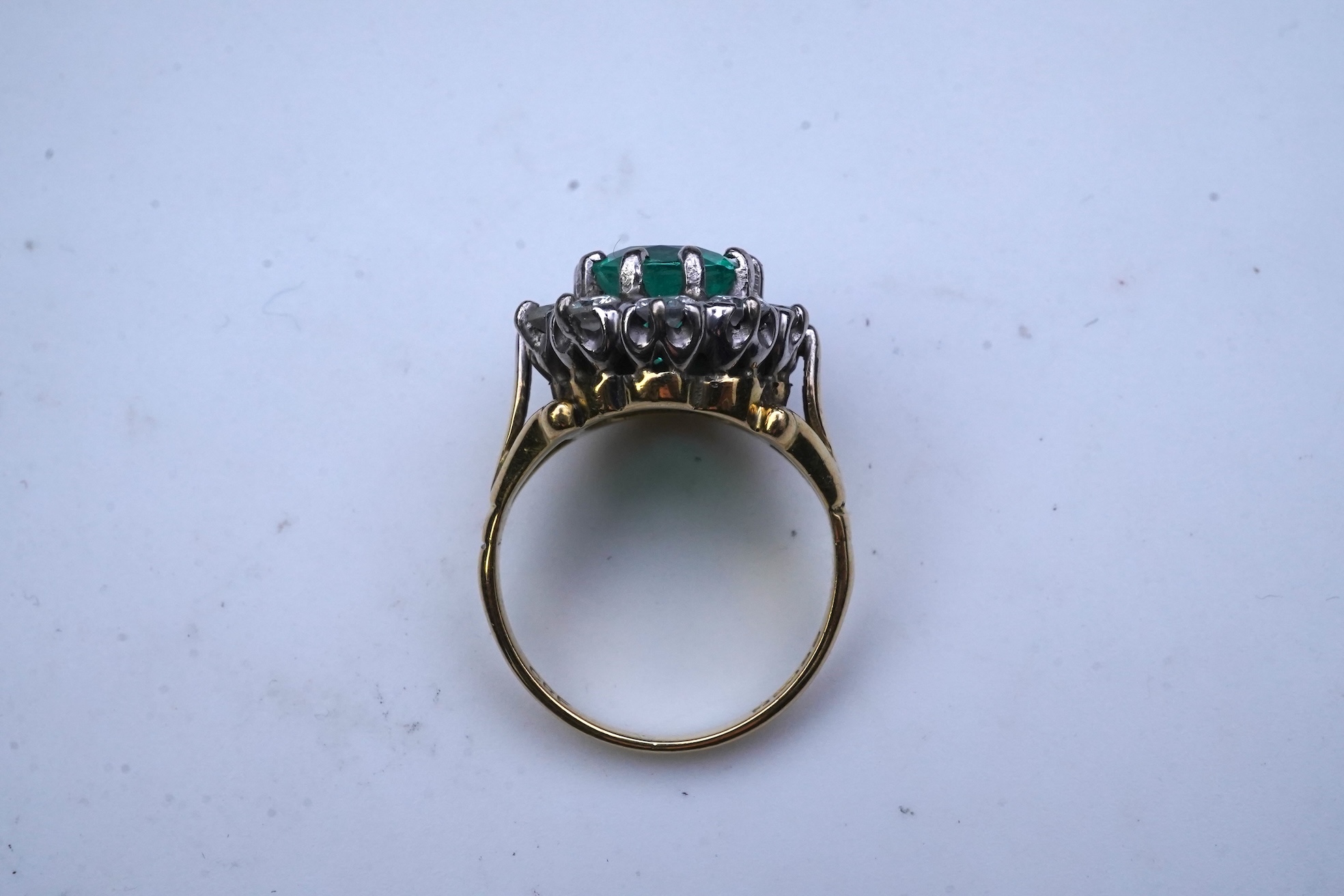 An emerald and diamond ring